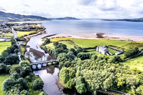 an aerial view of a river and a castle at The Harbour Inn in Buncrana