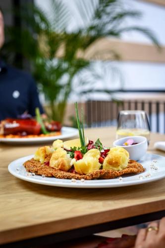a plate of food on top of a table at Grand Hotel Coroana in Bistriţa