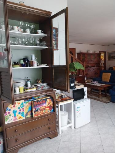 a living room with a cabinet and a microwave at A casa di Lara in Beura