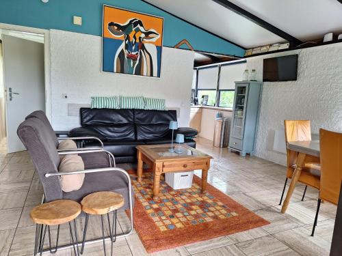 a living room with a couch and a table at Ferienhaus Waldidyll in Gerolstein