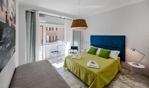 Un dormitorio con una cama verde y una ventana en Magenta Collection Fornaci, en Roma