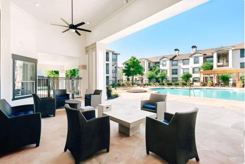 a patio with a table and chairs and a pool at Vibrant Oasis in the Heart of Midtown & Downtown in Houston