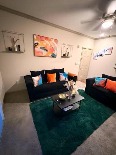a living room with a couch and a table at Vibrant Oasis in the Heart of Midtown & Downtown in Houston
