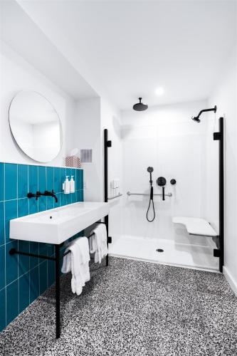 a bathroom with a tub and a sink and a shower at The Nevada in York