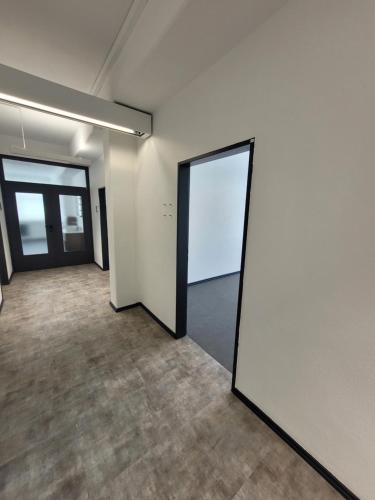an empty room with two doors and a mirror at Casa Mediteran NEU in Reichensachsen