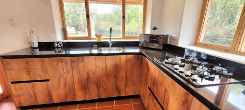a kitchen with a counter with a stove top oven at Casa Ecológica Al Pie Del Volcán in Otavalo