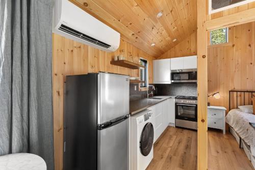 a kitchen with a refrigerator in a tiny house at Vermont Scandinavian Chalet-Brévent in Wolcott