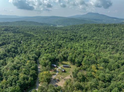 an aerial view of a forest with mountains in the background at Vermont Scandinavian Chalet-Courchevel in Wolcott