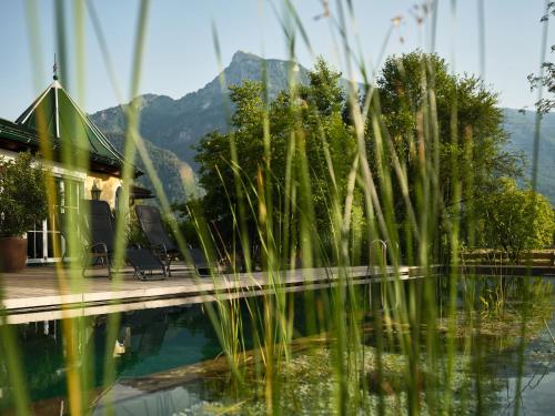 a house with a swimming pool with mountains in the background at Bloberger Hof in Salzburg