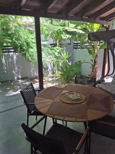 a wooden table and chairs on a patio at Sweet cottage in Chanioporta in Heraklio Town