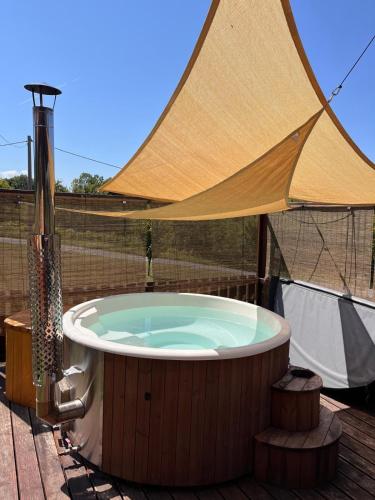 a hot tub with a tent on a deck at Kuća za odmor Markoci in Rakovica