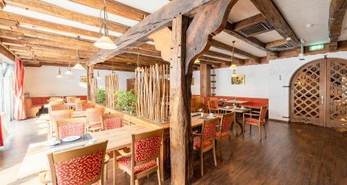 a dining room with wooden tables and chairs at Best Western Hotel Heidehof in Hermannsburg