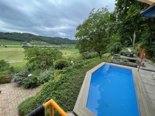a swimming pool on a patio with a view of a field at Ferienparadies Bodensee Fewo1 in Owingen