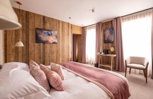 a bedroom with a bed with pillows on it at The Stroud Hotel in Stroud