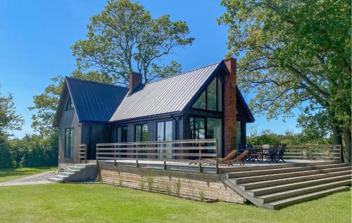 a house with a metal roof on a lawn at Pet Friendly Home In Löttorp With Wifi in Löttorp