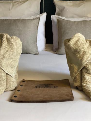 a tray sitting on top of a bed with pillows at The Baobab Bush Lodge and Villa in Hoedspruit