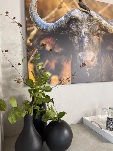 a painting of a bull with horns on a wall at The Baobab Bush Lodge and Villa in Hoedspruit
