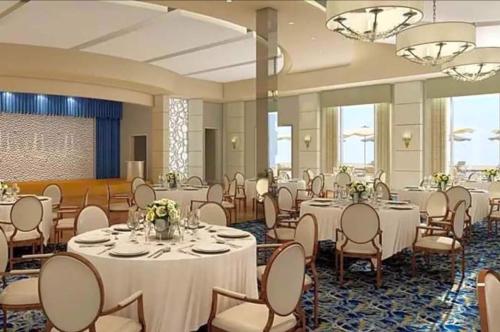 a banquet hall with white tables and chairs at Riverview Penthouse in Fort Myers