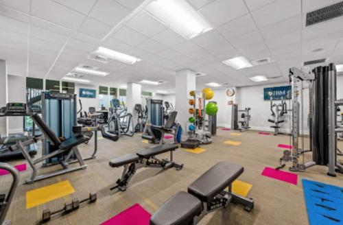 a gym with several treadmills and cardio machines at Riverview Penthouse in Fort Myers