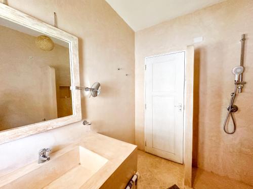 a bathroom with a sink and a mirror at Dream House in Watamu