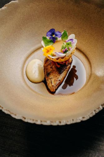 a plate with a piece of bread with flowers on it at Hotel PURS in Andernach