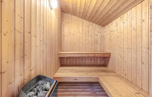 a wooden sauna with a tub in the middle at Holiday Home Råde Strandpark Haderslev Xii in Årøsund