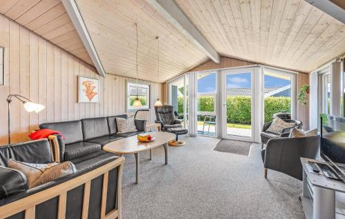 a living room with a couch and a table at Holiday Home Råde Strandpark Haderslev Xii in Årøsund