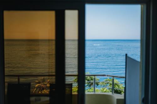 a view of the ocean from a window at MonteCasa Seaview Rooms in Dobra Voda