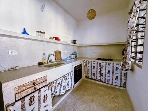 a kitchen with a sink and a counter top at Dream House in Watamu