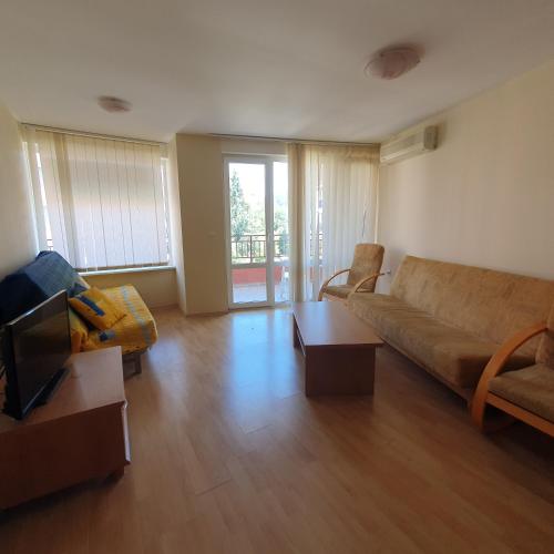 a living room with a couch and a table at Privilege Accommodation in Elenite
