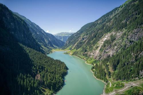an aerial view of a river between two mountains at Pension Waldegg in Hippach
