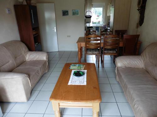 a living room with two couches and a coffee table at Ferienwohnungen Waldsicht und Dorfsicht in Winkel