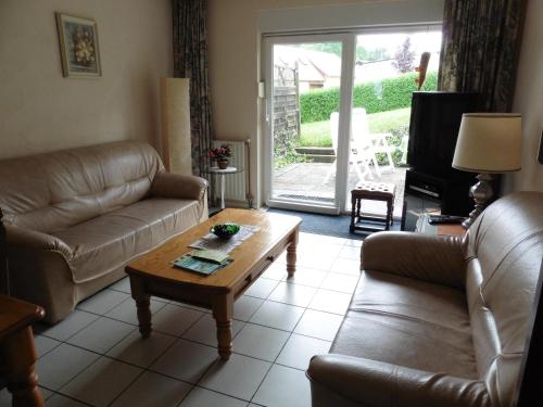 a living room with a couch and a coffee table at Ferienwohnungen Waldsicht und Dorfsicht in Winkel