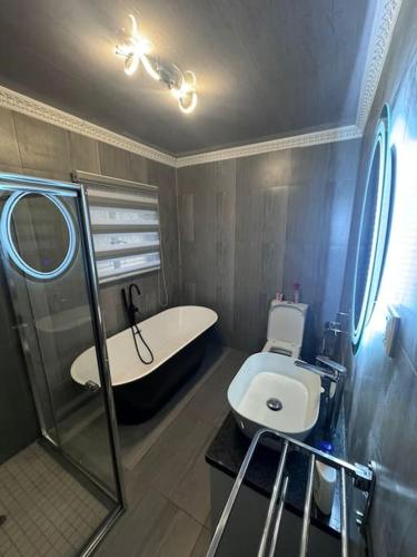 a bathroom with a tub and a toilet and a sink at 1568 on Mukwa in Harare