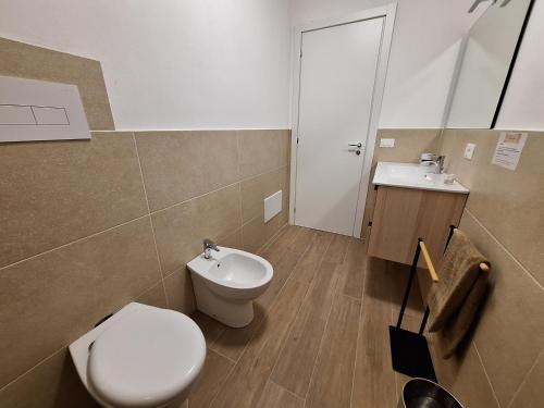 a bathroom with a toilet and a sink at Domus Levante in Terrasini