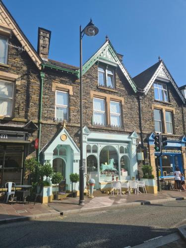 a building with tables and chairs in front of it at Heart of Windermere in Windermere