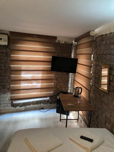 a living room with a flat screen tv on a wall at Cihangir apart in Istanbul