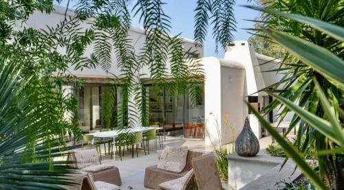 a house with a courtyard with chairs and plants at Calma Blanca in Castries