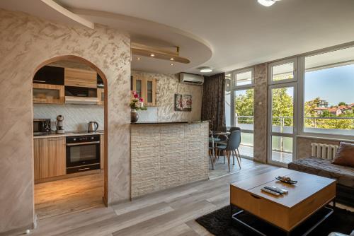 a living room and kitchen with a couch and a table at Apartments Rosina in Plovdiv