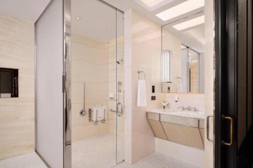 a bathroom with a shower and a sink at The Peninsula London in London