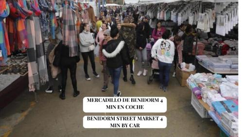 a group of people walking around a store at Apartamento Completo Torresol I in Benidorm