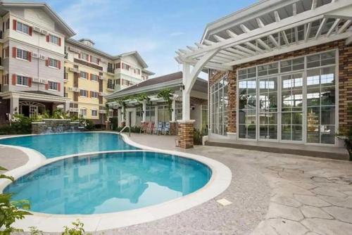 a swimming pool in front of a building at Apple One Banawa Heights Cebu City Cheap & High Quality in Cebu City