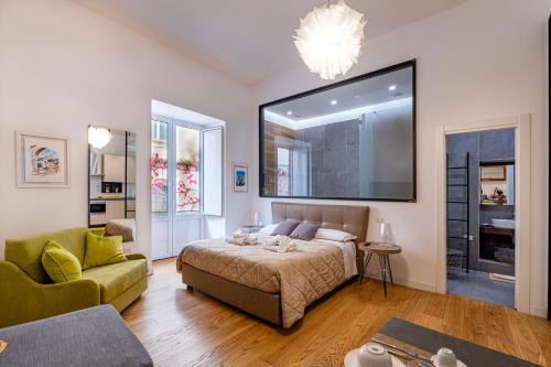 a living room with a bed and a couch at La dimora del barone in Salerno