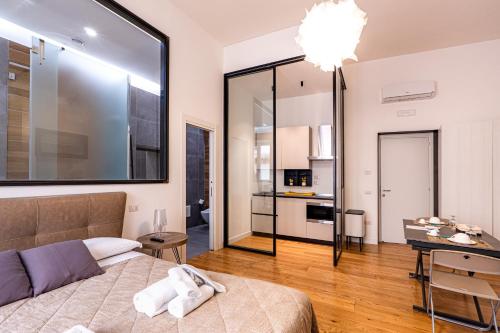 a bedroom with a bed and a dining room at La dimora del barone in Salerno