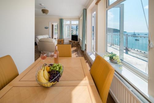 a bowl of fruit on a wooden table in a room at The Penthouse in Totland