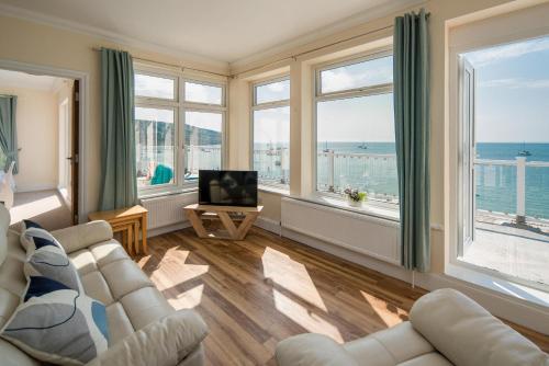 a living room with a view of the ocean at The Penthouse in Totland