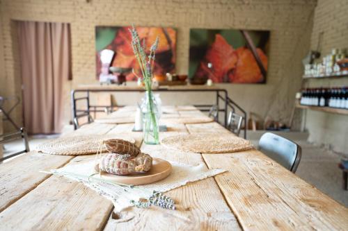 a long wooden table with two pastries on it at CA'du LIN - Jacuzzi e Piscina in Cisterna dʼAsti