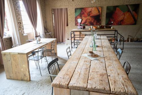 a large wooden table in a room with chairs at CA'du LIN - Jacuzzi e Piscina in Cisterna dʼAsti