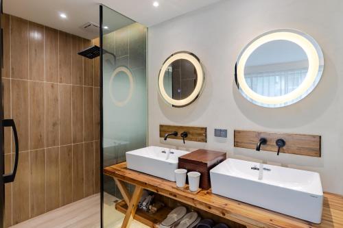 a bathroom with two sinks and a mirror at 问安民宿（黄山风景区店） in Huangshan Scenic Area