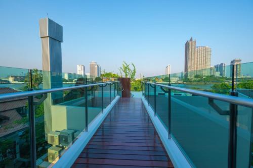a balcony with a view of the city at WE HOTEL RIVERFRONT in Bang Su